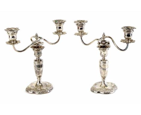 Pair of Regency style small silver double-stemmed candelabras, knopped columns to flower-head pedestal base, embossed with fl