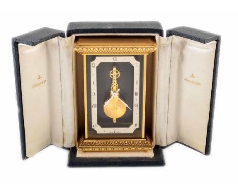 A brass frame Jaeger-LeCoultre carriage clock. With suspended Roman numeral chapter ring framing the visible swiss-made movem