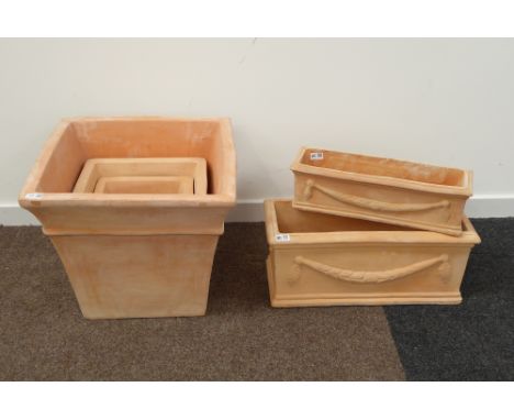 Three graduating tapered terracotta planters, (W54cm) together with two graduating trough shaped terracotta planters, W61cm C