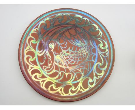 Burmantofts Faience lustre wall plate by Joseph Walmsley with scroll and floral design on a ruby ground, impressed marks and 