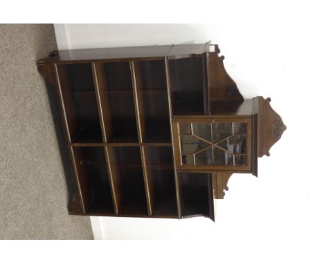 Edwardian walnut open bookcase, raised back with incised scrolled decoration, projecting dentil cornice over central astragal