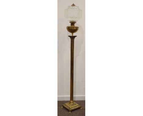 Early 20th century converted cast brass Corinthian column standard oil lamp, with cut glass shade, raised on hairy paw feet, 