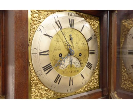 18th century oak longcase clock, sarcophagus top over projecting cornice, split plain pilasters with gilt wood decoration, br