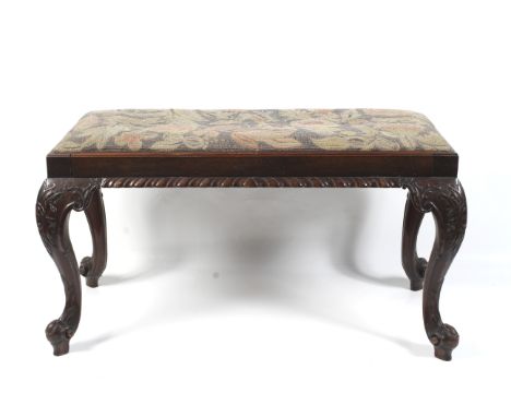 A 19th century mahogany fender stool. With tapestry drop in set over carved cabriole legs. Total L85cm