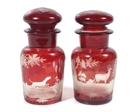 A pair of 19th century Bohemian Glass ruby red cameo cut pickle jars. Decorated with deer in wood, hunting dog and stag, H7.3