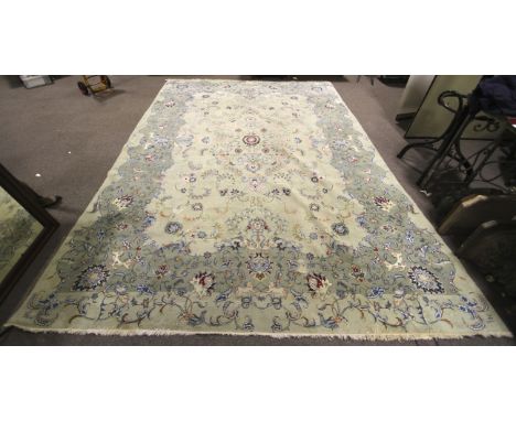 A mid-20th century hand made carpet/large rug with light sage green ground. Decorated with birds, animals, floral and foliate