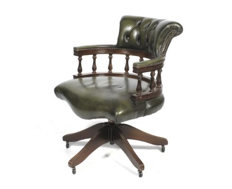 A Victorian style green leather(?) button back swivel captain's/desk chair. With turned column open back, raised on a five-po