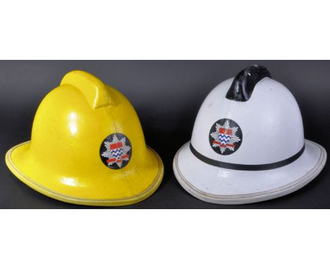 Two vintage 1980's Helmets Ltd Cromwell made London Fire Brigade Firefighter F135 helmets. A white and yellow example of comp