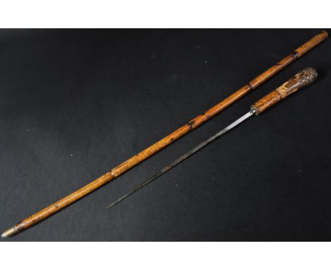 A 19th Century hardwood / bamboo walking stick cane with concealed blade. The cane having a rounded pommel and square section