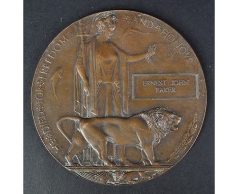 A WWI First World War commemorative death plaque / death penny medal, for one Ernest John Baker. Bronze construction, in typi