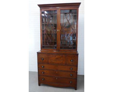 Early 19th century mahogany and ebony inlaid secretaire bookcase, the stepped cornice above a pair of astragal glazed doors w