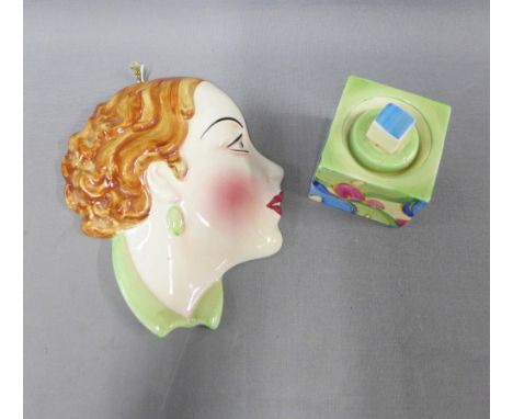 Clarice Cliff Fantasque Bizzare inkwell, (the cover repaired) and a C&amp;Co pottery face wall mask, 17cm (2) 