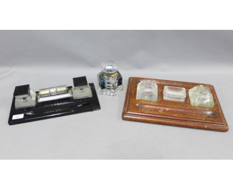 Early 20th century desk inkwells to include a black glass desk stand with chrome calendar, oak desk stand and a heavy glass i