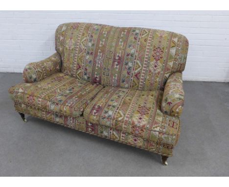 Two seater sofa with Kelim style upholstery, on turned mahogany legs with brass caps and ceramic castors, 150 x 82 x 60cm 