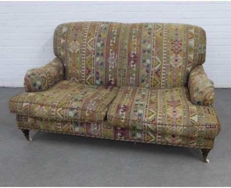 Two seater sofa with Kelim style upholstery, on turned mahogany legs with brass caps and ceramic castors, 150 x 82 x 60cm 