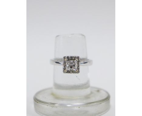 18ct white gold diamond ring with a brilliant cut square diamond within a surround of sixteen smaller diamonds, UK ring size 