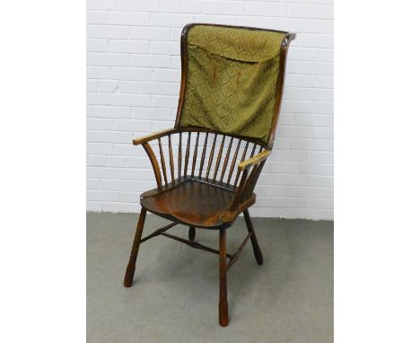 Late 19th / early 20th century wing high back Windsor chair with an upholstered and comb back, open arms and solid seat, with