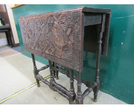 CARVED OAK DROP LEAF TABLE, top with carved geometric patterns on slender turned frame, 55cm width 