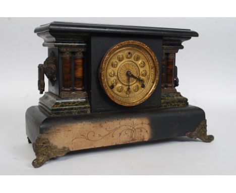 A Victorian faux slate and marble mantel clock (wood construction), with original gilt fixtures, with decorative enamel face.