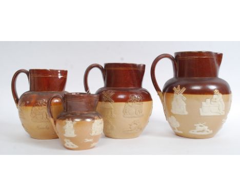 A collection of Doulton Lambeth stoneware jugs having hunting scenes with stag and dogs, windmills etc. Jugs being impressed 
