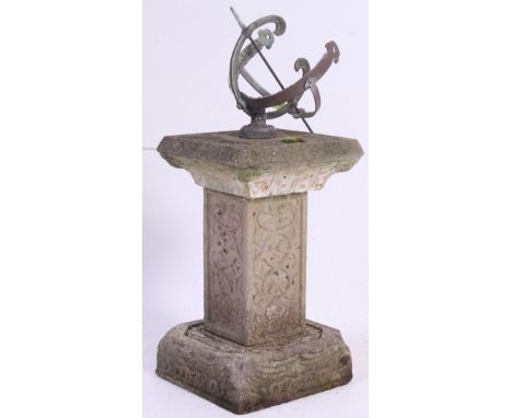 A cast metal ring sundial, having Roman numerals to the centre ring mounted on a well weathered reconstituted stone column an