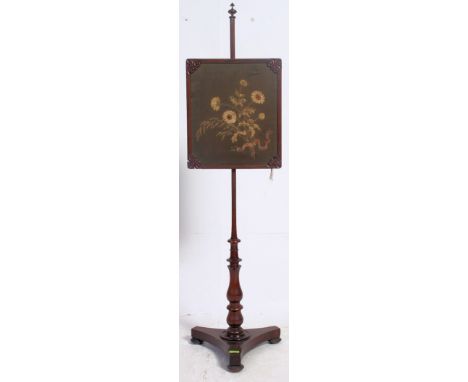 A 19th century Georgian Rosewood rise and fall pole screen. Raised on a tripod base with central square needlepoint panel hav
