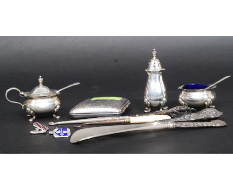 A silver plated Barkers Bros condiment set with blue glass liners. Together with a silver plate chase decorated cigarette cas