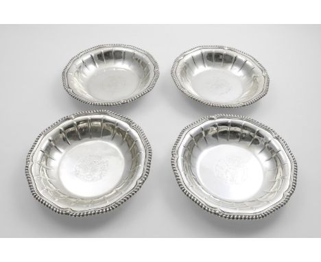 LOCAL INTEREST:- A set of four George III vegetable dish bases of shaped circular outline, with later-fluting around the side