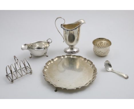 A MIXED LOT:- A small salver with an inscription on the reverse, a sauce boat, an American cream jug, a toast rack, a small s