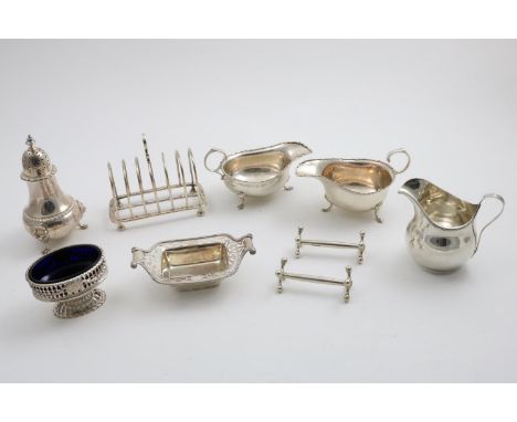 A MIXED LOT:- A George V toast rack with seven arched bars, by Messrs. Hutton &amp; Sons Ltd., Sheffield 1930, a pair of sauc