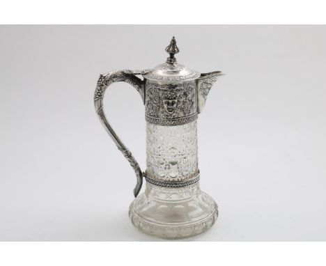 A LATE VICTORIAN MOUNTED CUT-GLASS CLARET JUG with a star-cut base, the mount decorated in relief with fruiting vines &amp; B