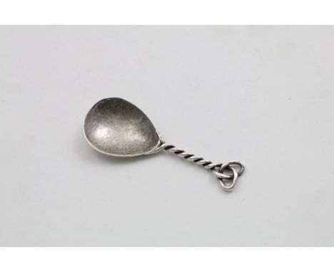 AN ARTS AND CRAFTS CADDY SPOON with a hammered drop-shaped bowl and a wire stem and terminal, unmarked 1910-1930;  3.1"  (8 c