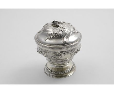 AN EARLY GEORGE III CIRCULAR COVERED BOWL in the form of an urn decorated with wrythen fluting and chased floral garlands, re