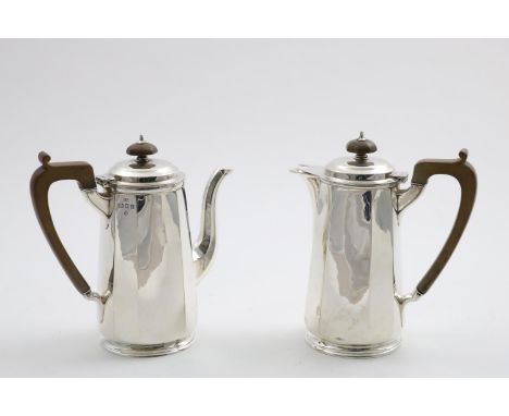 A PAIR OF GEORGE V CAFE AU LAIT POTS with tapering octagonal bodies and low-domed covers, by George Howson, London/Sheffield 