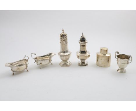 A MIXED LOT:- A pair of small, late Victorian sauce boats, a George V oval tea caddy, two sugar casters and a small Edwardian