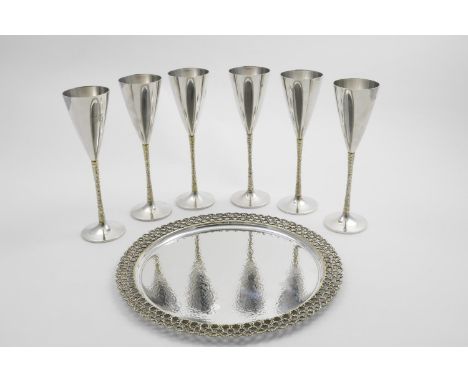 BY STUART DEVLIN:- A set of six Elizabeth II parcelgilt champagne goblets with textured stems, initialled "H", London 1977/78