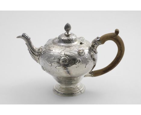 AN EARLY GEORGE III TEA POT the inverted baluster body with chased and repousse-work flowers around the upper body, and a wry