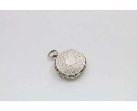 A VICTORIAN VINAIGRETTE  resembling a pocket watch with a chased scroll border and engine-turned front and back, gilt interio