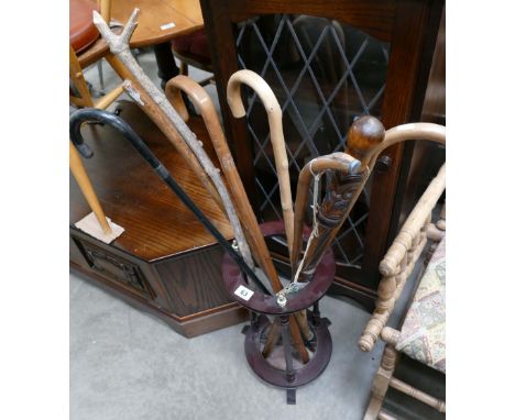 A variation of 8 walking sticks, including a 'Toka Toka' and walking stick holder. (9)