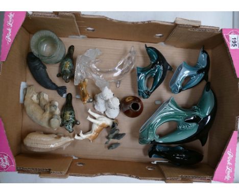A collection of items to include Poole Pottery glass dolphins, ceramic seals, etc. (16 pieces)