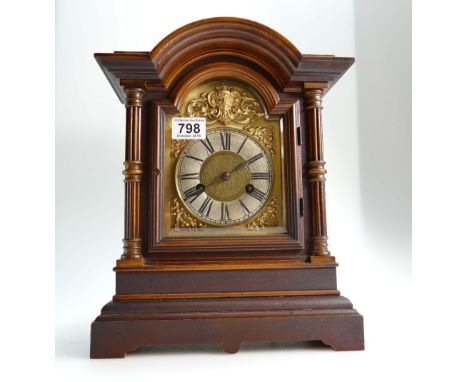 Victorian walnut mantle clock with decorative brass face, height 36cm