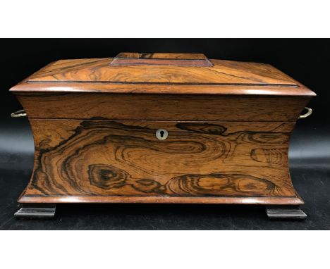 A rosewood tea caddy with a hinged lid, two ring handles, key and working lock, mother of pearl escutcheon, interior with two