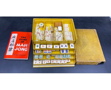 A vintage cased Mahjong set with bamboo and boned tiles, handbook etc. 