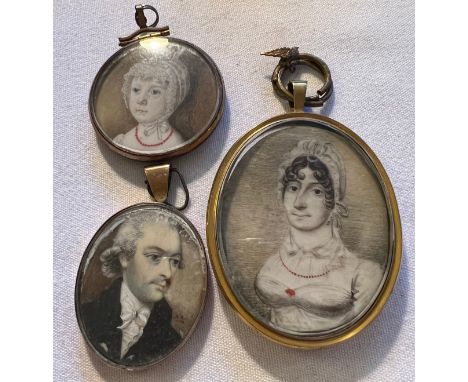 Three portrait miniatures on ivory. One lady, one gentleman and a child. Hair to reverse of one. Largest 6.5 x 5.5cm. Ivory s