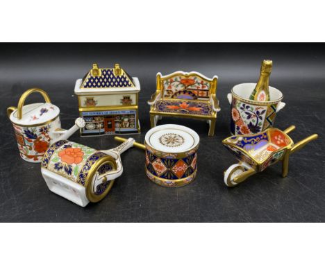 A group of Royal Crown Derby porcelain miniature items, comprising toy drum with drumsticks, champagne bucket and bottle with