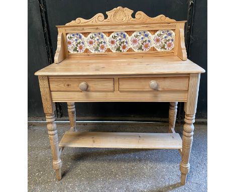 A pine washstand with tiled back and two drawers and shelf below. 108 h x 90 w x 44cm d. 