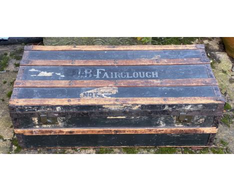 An early 20thC wood and metal bound steamer trunk belonging to J.B.Fairclough, with carry handle to each end. 