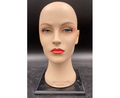 A painted Zepla mannequin head on stand, 31cm h with false eyelashes 