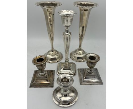 Hallmarked silver comprising a pair of vases Birmingham Williams Ltd 21cm h, a pair of candlesticks Sheffield 1912 Harrods St