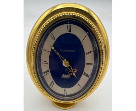 A Jaeger LeCoultre 8-Day Alarm clock, with a hand-wound swiss movement in a brass oval case. 9cm h. 